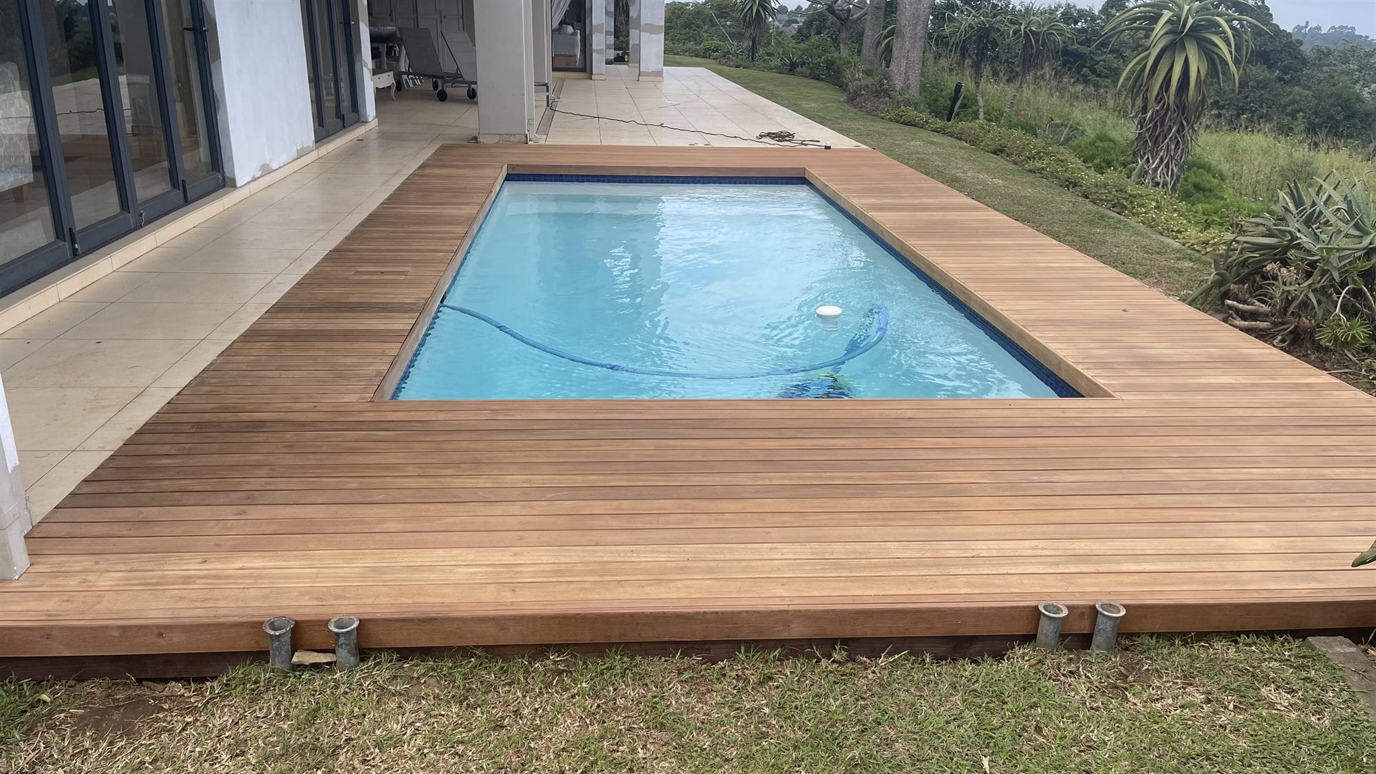 Contemporary hardwood pool deck with valley views